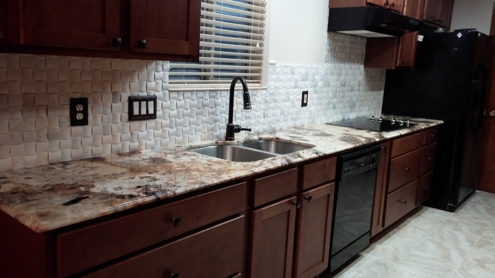Traditional galley kitchen in Houston with a double-bowl sink, shaker cabinets, dark wood cabinets, granite benchtops, white splashback, stone tile splashback, coloured appliances, no island and travertine floors.