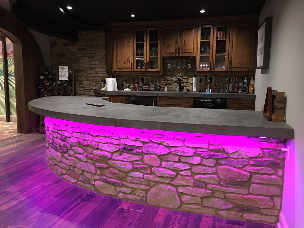 Photo of a large country galley seated home bar in Other with distressed cabinets, wood benchtops, brown splashback, timber splashback, slate floors, grey floor and brown benchtop.