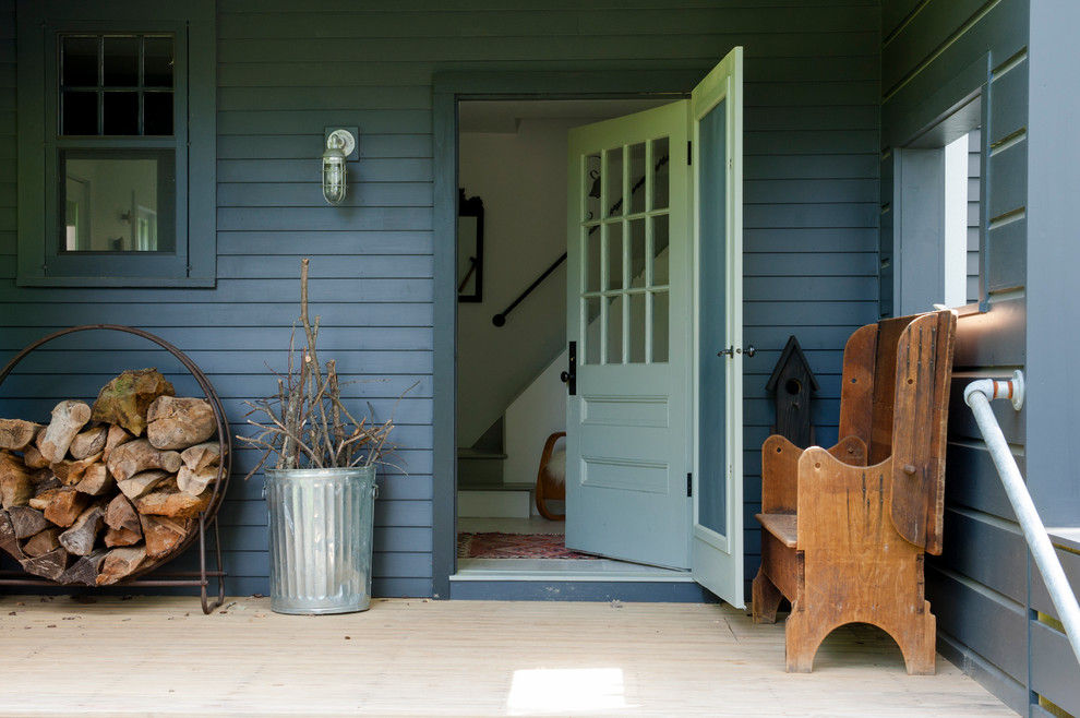 Small classic side porch idea in New York with decking