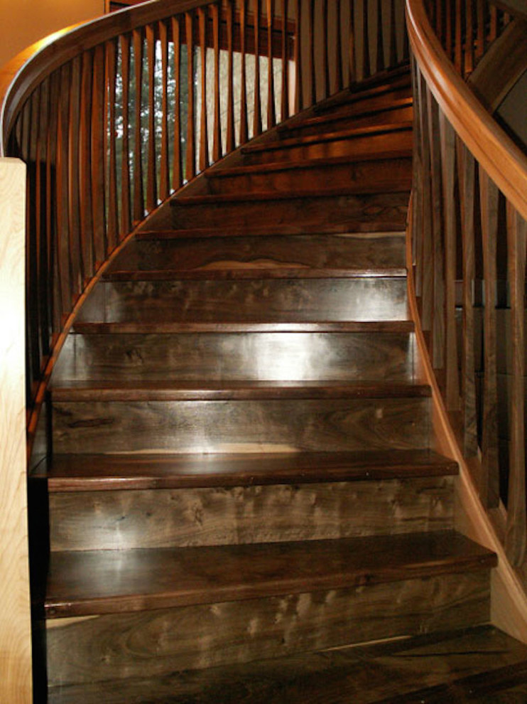 Photo of a large country wood curved staircase in Seattle with wood risers.