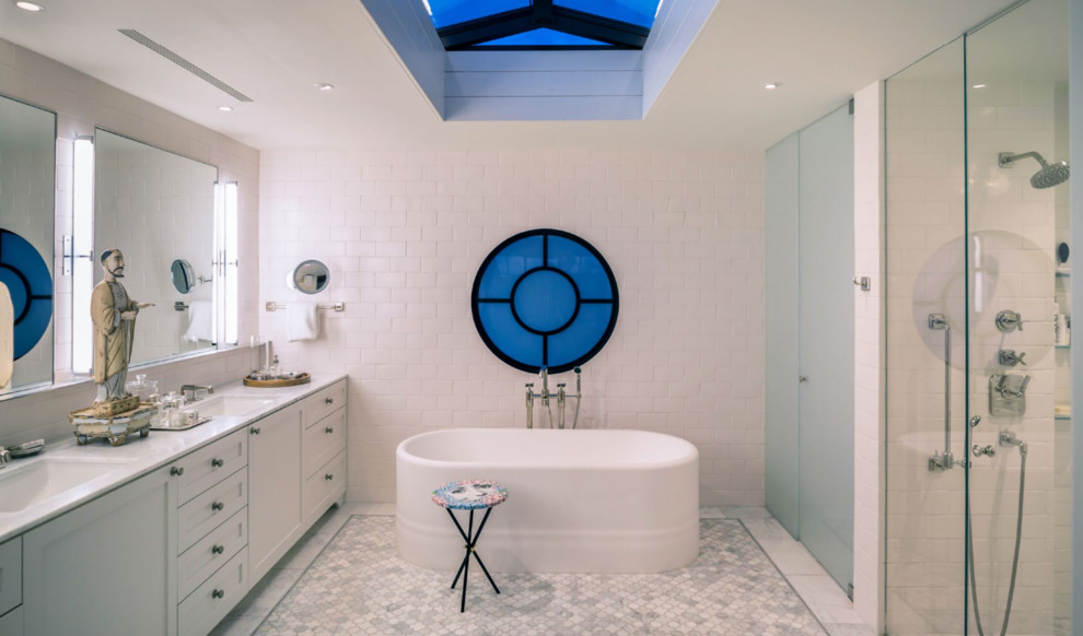 Inspiration for a large contemporary master bathroom in San Diego with shaker cabinets, white cabinets, a freestanding tub, an alcove shower, white tile, cement tile, white walls, marble floors, an undermount sink, marble benchtops, white floor, a hinged shower door and white benchtops.