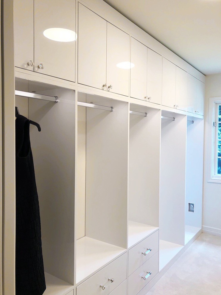 Photo of an expansive modern women's walk-in wardrobe in Seattle with flat-panel cabinets, white cabinets, carpet and white floor.