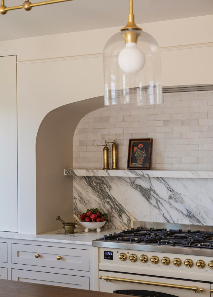Example of a large classic eat-in kitchen design in Seattle with shaker cabinets, beige cabinets, marble countertops, marble backsplash, an island and white countertops