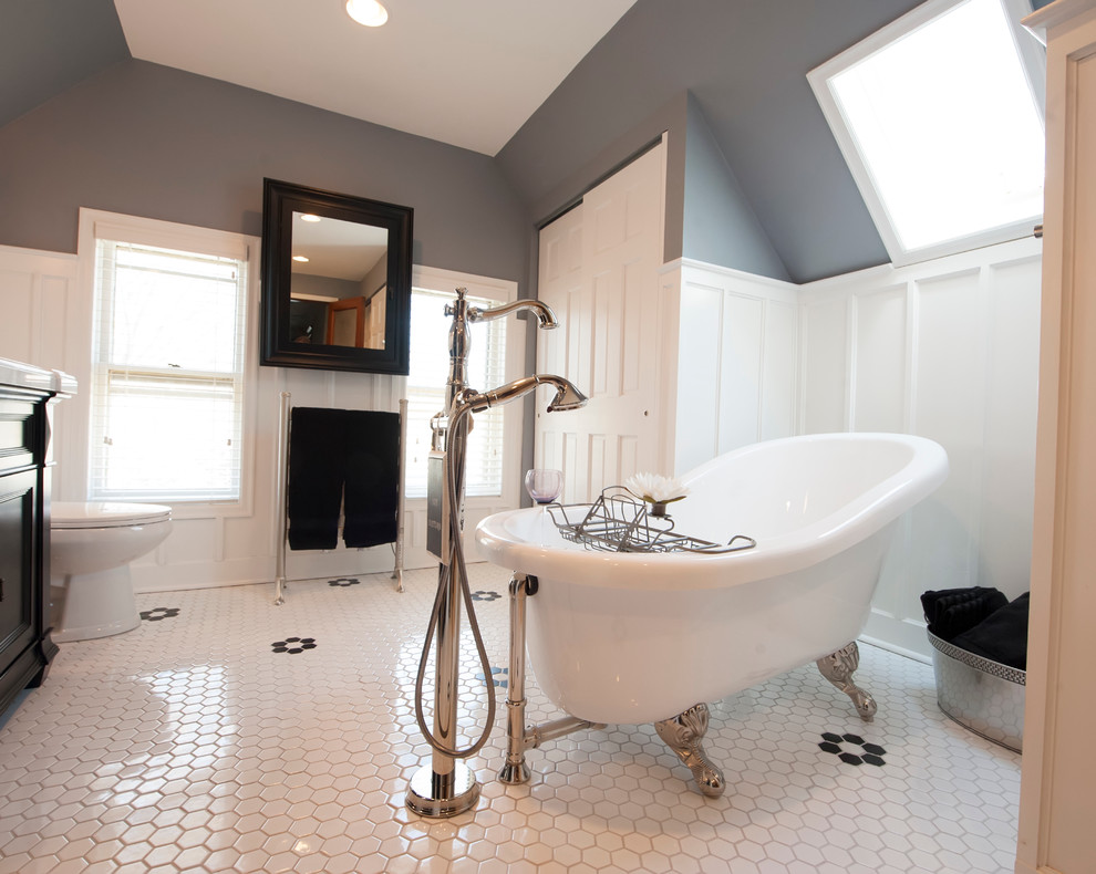 Inspiration for a mid-sized contemporary master bathroom in Columbus with recessed-panel cabinets, black cabinets, a freestanding tub, a corner shower, white tile, ceramic tile, grey walls, porcelain floors, a drop-in sink and marble benchtops.