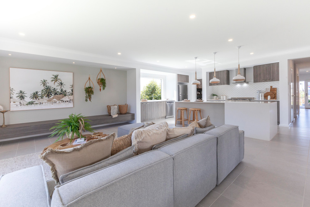 Large tropical open concept family room in Melbourne with grey walls, ceramic floors and grey floor.