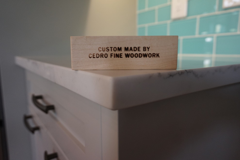Inspiration for a mid-sized transitional l-shaped medium tone wood floor and brown floor kitchen remodel in Calgary with an undermount sink, shaker cabinets, gray cabinets, quartz countertops, blue backsplash, ceramic backsplash, stainless steel appliances and an island