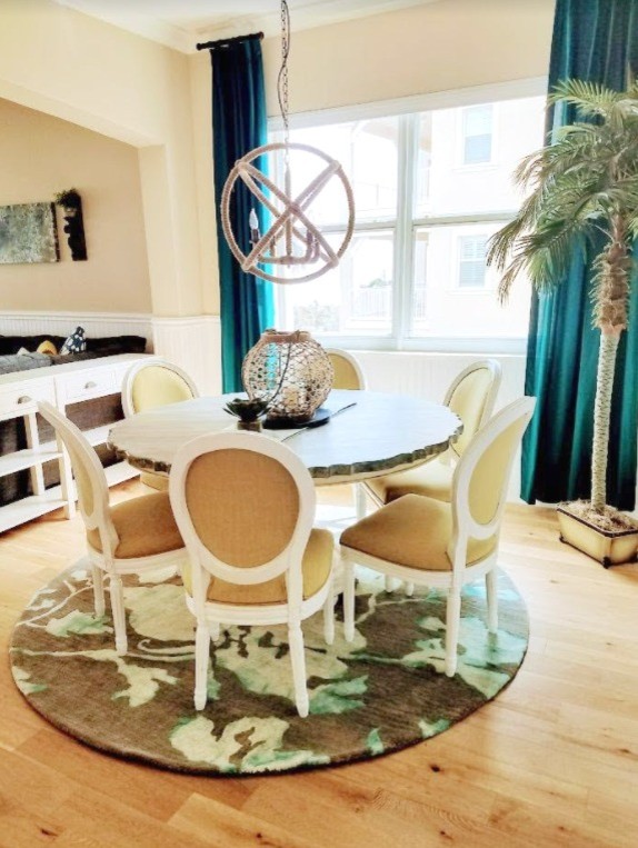 Inspiration for a beach style dining room in Atlanta with beige walls, light hardwood floors and no fireplace.