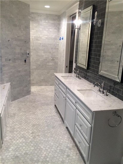 Photo of a mid-sized transitional master bathroom in Milwaukee with raised-panel cabinets, white cabinets, black tile, gray tile, white tile, mosaic tile, grey walls, mosaic tile floors, an undermount sink and marble benchtops.