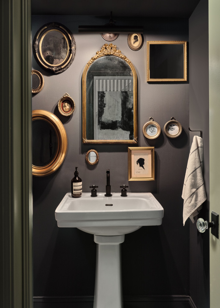 Eclectic powder room in New York with grey walls and a pedestal sink.