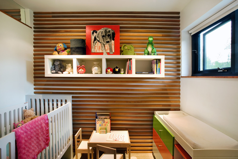 This is an example of a small contemporary gender-neutral nursery in Denver.