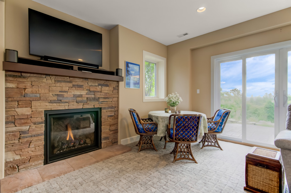 This is an example of a large traditional living room in Denver with a standard fireplace and a stone fireplace surround.