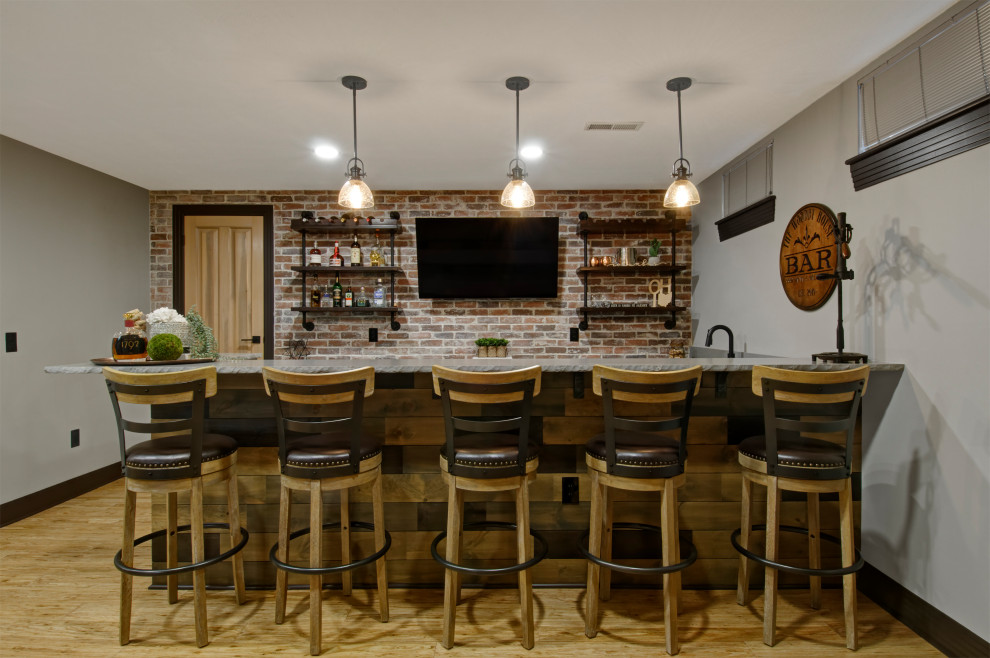 Large country home bar in Columbus with bamboo floors and beige floor.