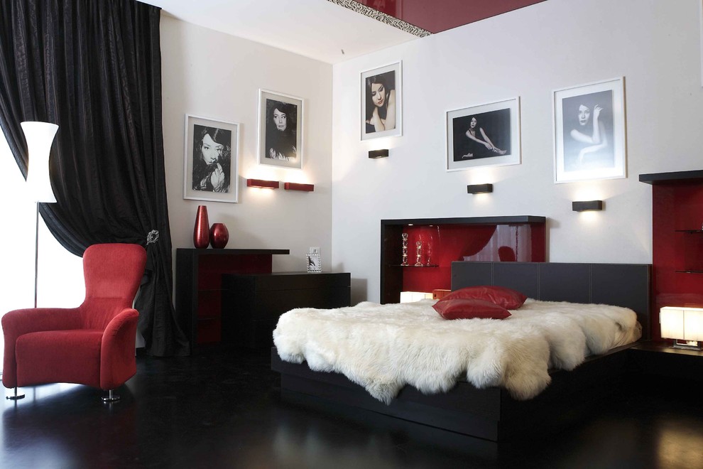 This is an example of a contemporary bedroom with white walls, dark hardwood floors and black floor.
