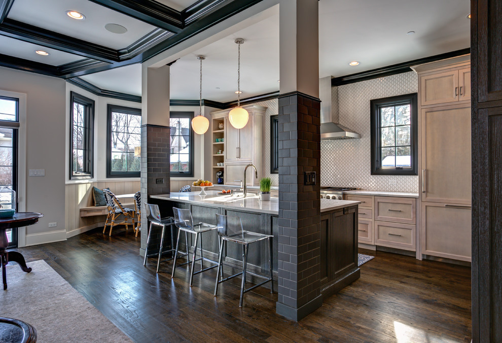 Inspiration for a transitional l-shaped open plan kitchen in Chicago with shaker cabinets, light wood cabinets, white splashback, panelled appliances, dark hardwood floors, with island, brown floor and white benchtop.