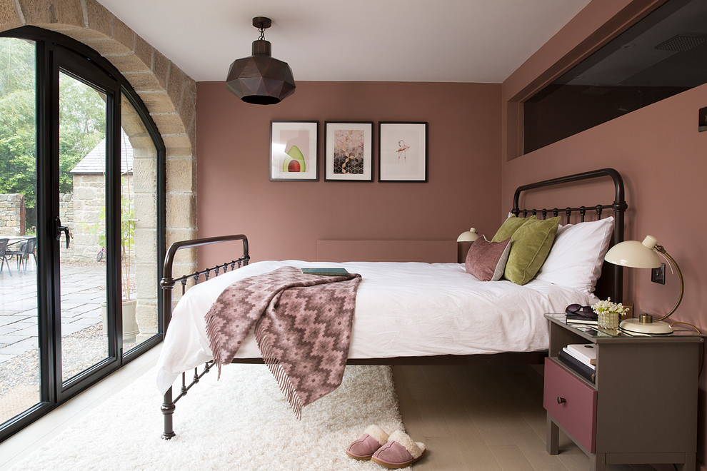 Design ideas for a mid-sized country bedroom in Other with pink walls, light hardwood floors and beige floor.
