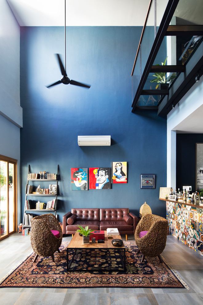 Photo of an eclectic formal enclosed living room in Singapore with blue walls, no tv and grey floor.