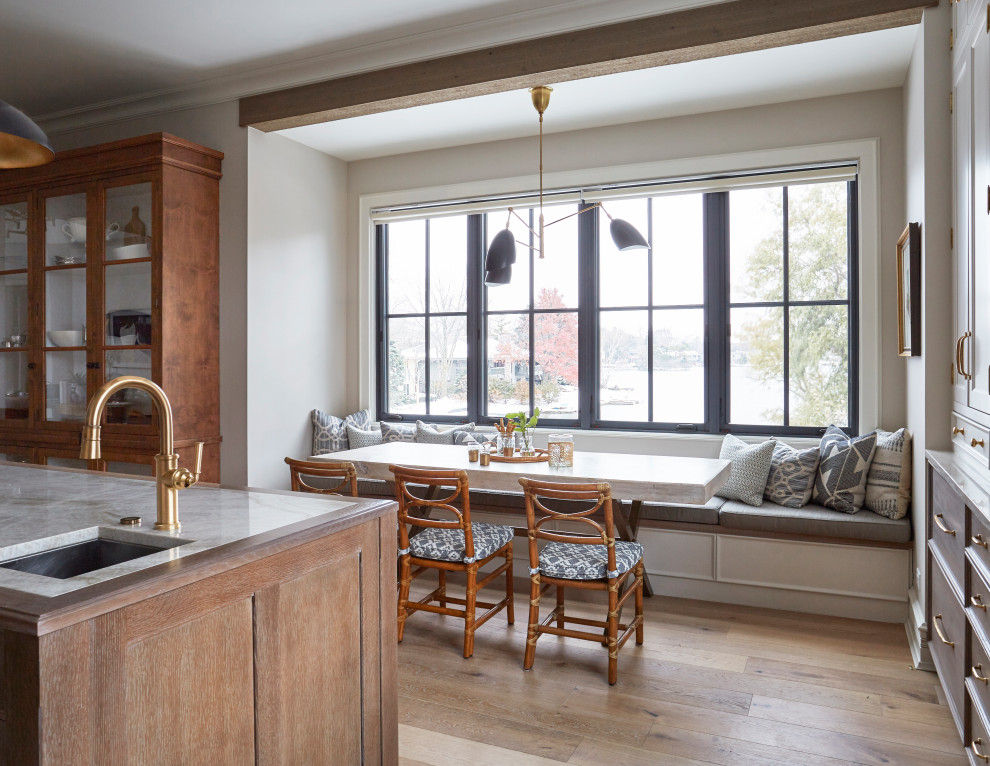 Photo of a transitional kitchen/dining combo in Chicago with light hardwood floors and brown floor.