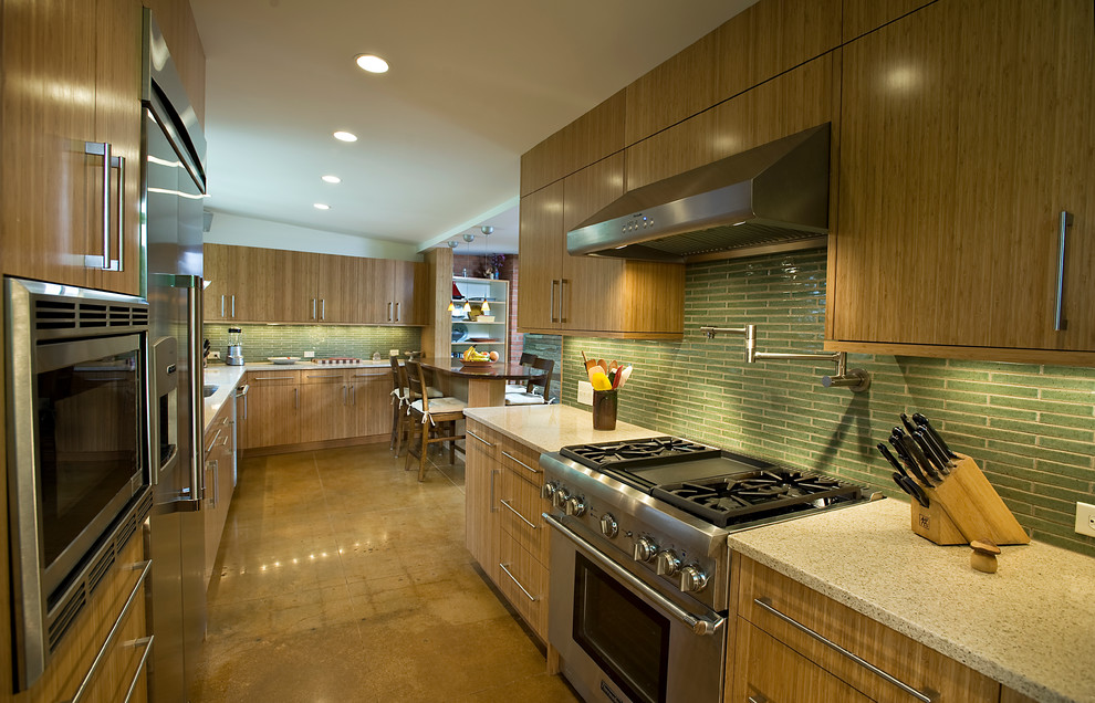 Open concept kitchen - mid-sized transitional galley concrete floor open concept kitchen idea in DC Metro with an undermount sink, flat-panel cabinets, green backsplash, stainless steel appliances, quartz countertops and glass tile backsplash