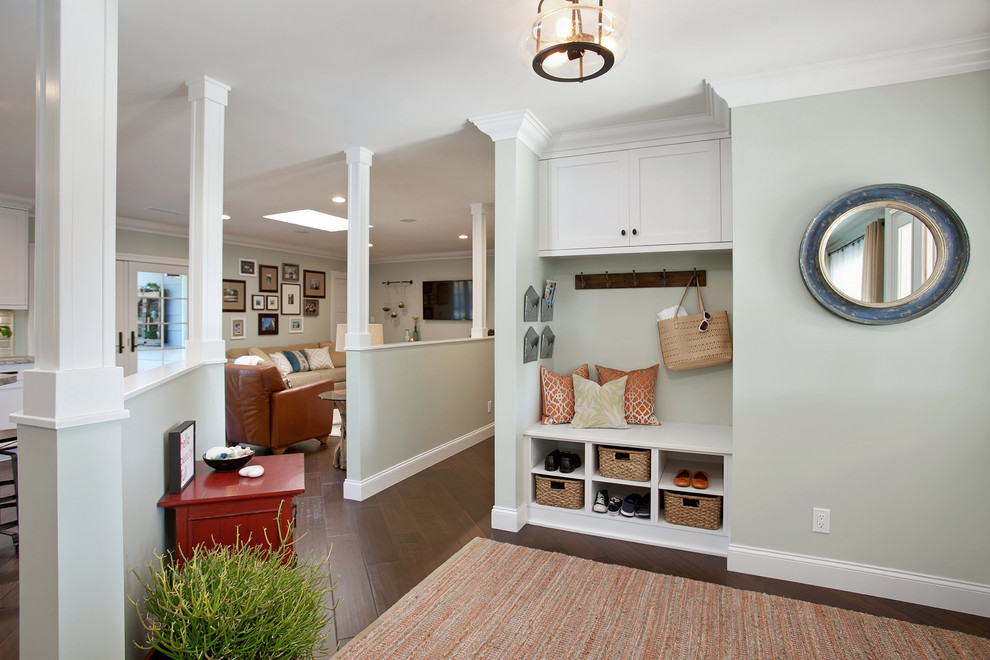 Inspiration for a traditional mudroom in San Diego with green walls and dark hardwood floors.