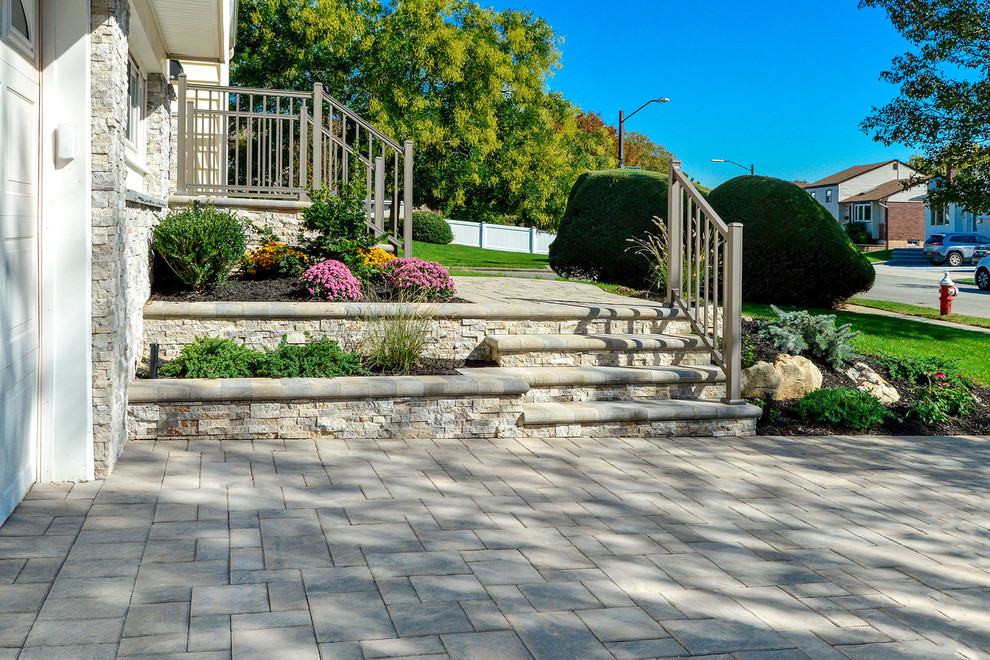 Inspiration for a traditional driveway in New York with a retaining wall.