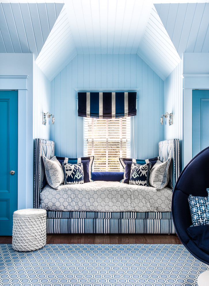 Mid-sized beach style loft-style bedroom in Boston with blue walls and medium hardwood floors.