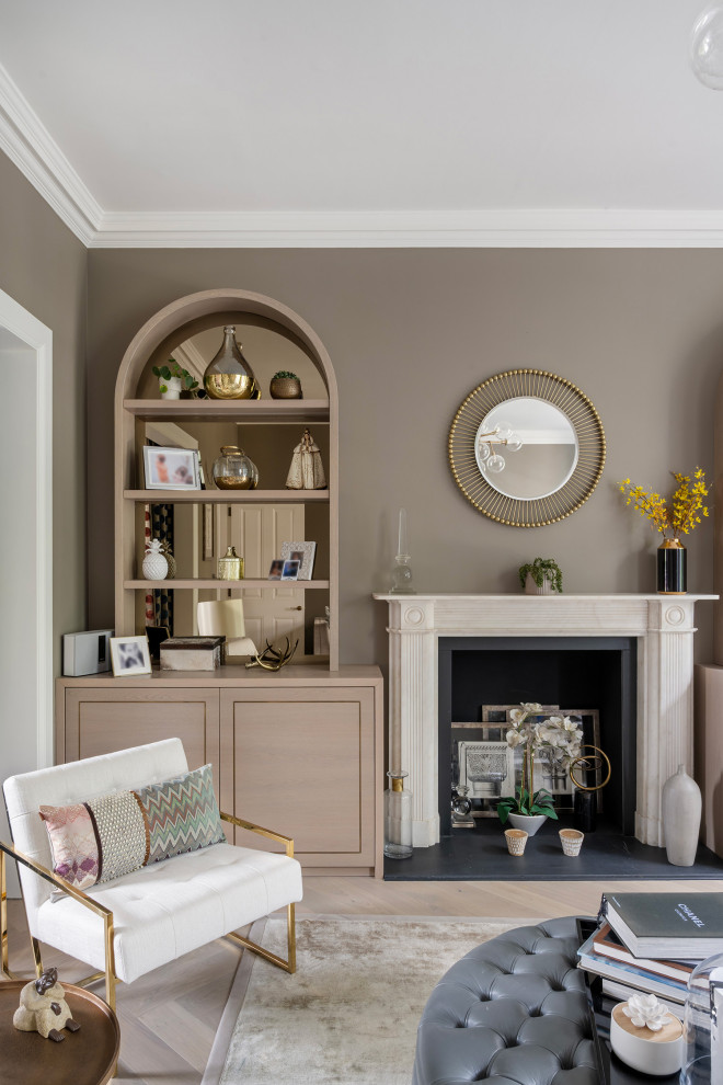 Photo of a large traditional formal enclosed living room in London with brown walls, light hardwood flooring, a standard fireplace, a stone fireplace surround, no tv and a coffered ceiling.