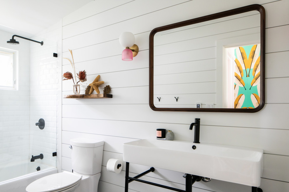 Photo of a coastal bathroom in New York with an alcove bath, a shower/bath combination, white tiles, metro tiles, white walls, a console sink, an open shower, a single sink and tongue and groove walls.