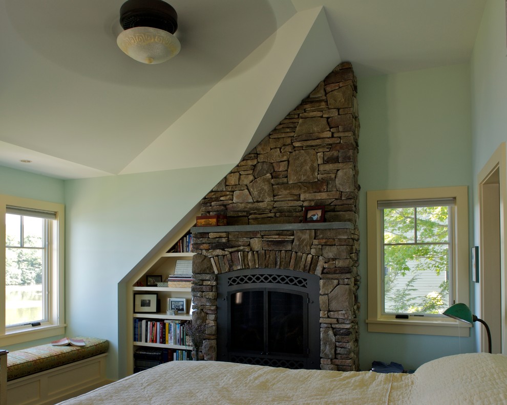 Mid-sized arts and crafts master bedroom in Boston with blue walls, a standard fireplace and a stone fireplace surround.