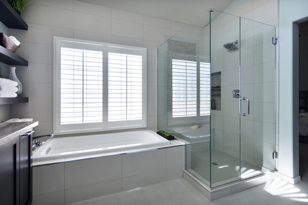 Inspiration for a mid-sized transitional master white tile drop-in bathtub remodel in Phoenix with shaker cabinets, dark wood cabinets, a one-piece toilet, blue walls, an undermount sink and a hinged shower door