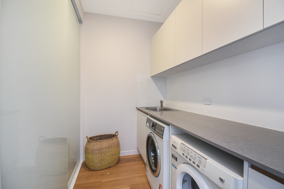 This is an example of a contemporary laundry room in Sunshine Coast.
