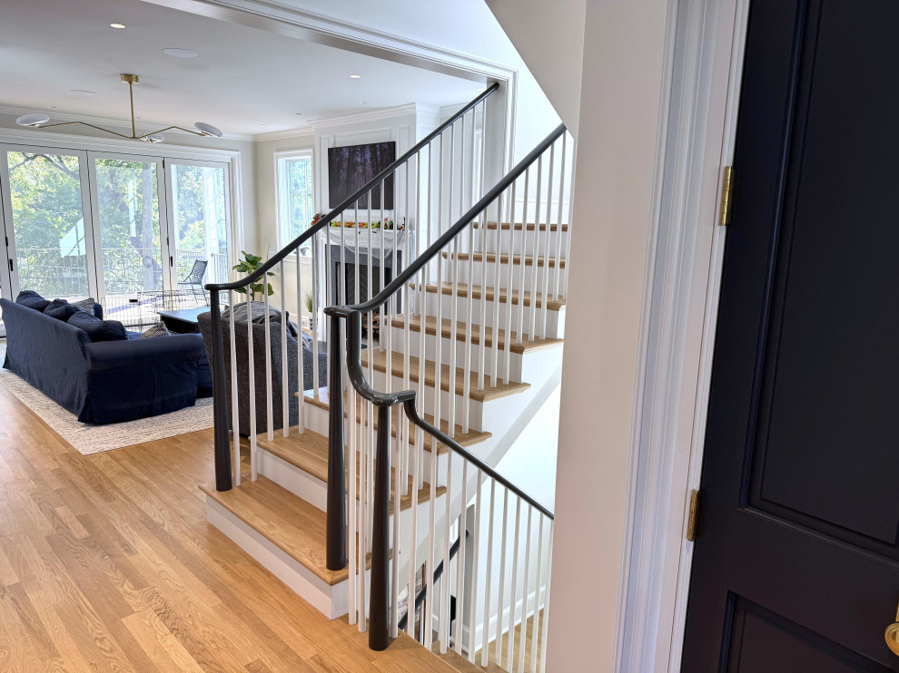 Staircase - mid-sized transitional wooden u-shaped wood railing staircase idea in DC Metro with painted risers