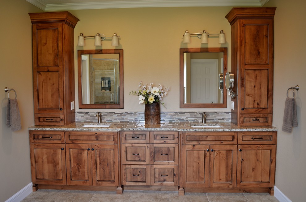 Mid-sized elegant master brown tile, gray tile and matchstick tile ceramic tile and beige floor bathroom photo with beaded inset cabinets, medium tone wood cabinets, beige walls, an undermount sink, granite countertops and gray countertops