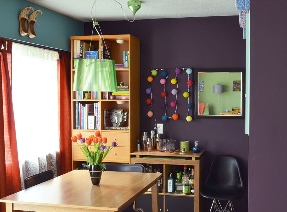 Photo of a small midcentury separate dining room in Vancouver with purple walls.