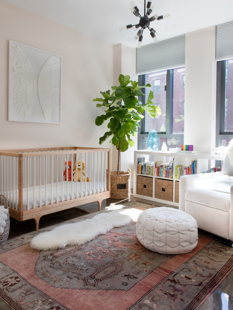 Photo of a transitional nursery for girls in Boston with pink walls.