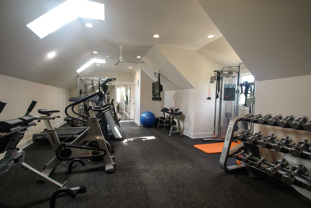 Large transitional home weight room in Milwaukee with beige walls.