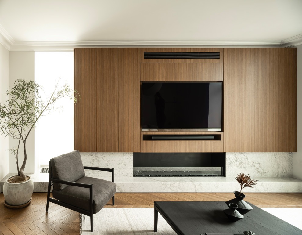 This is an example of an expansive contemporary formal open concept living room in London with brown walls, dark hardwood floors, a stone fireplace surround, a built-in media wall and brown floor.