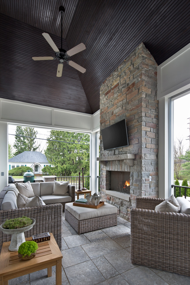 Design ideas for a large transitional sunroom in Detroit with a standard fireplace, a stone fireplace surround, a standard ceiling and grey floor.