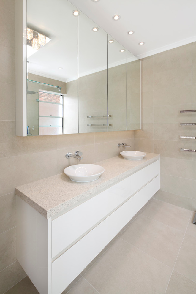 Small contemporary master bathroom in Sydney with flat-panel cabinets, white cabinets, quartzite benchtops, beige tile, ceramic tile, beige walls and porcelain floors.