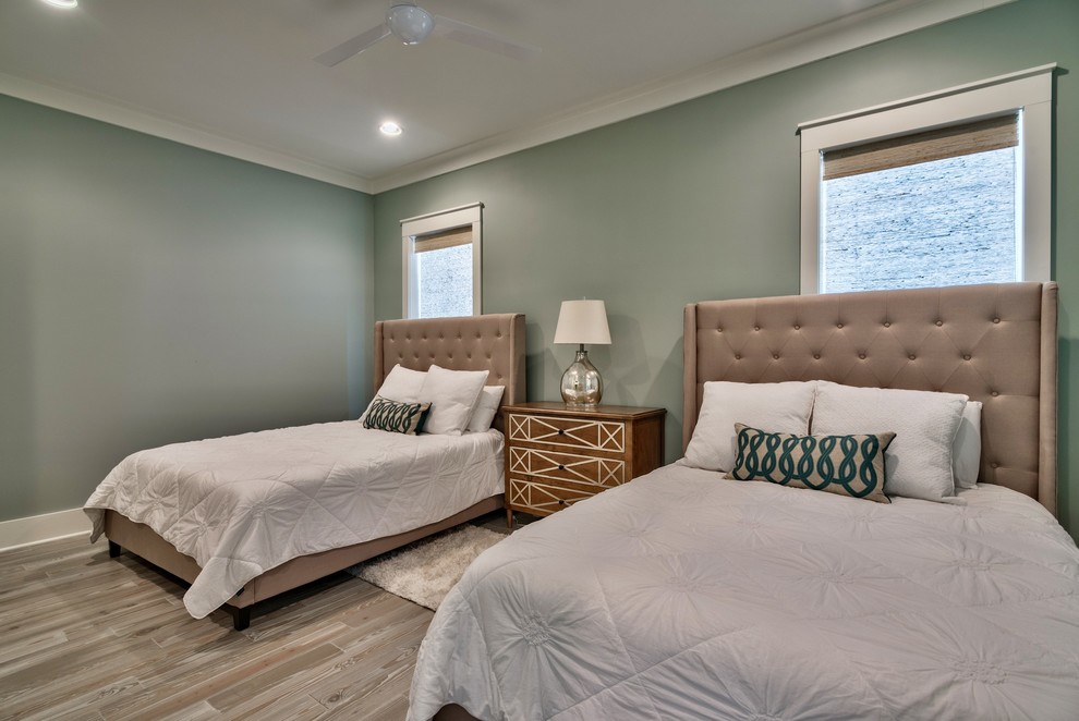 Large guest bedroom in Miami with green walls, light hardwood floors and no fireplace.
