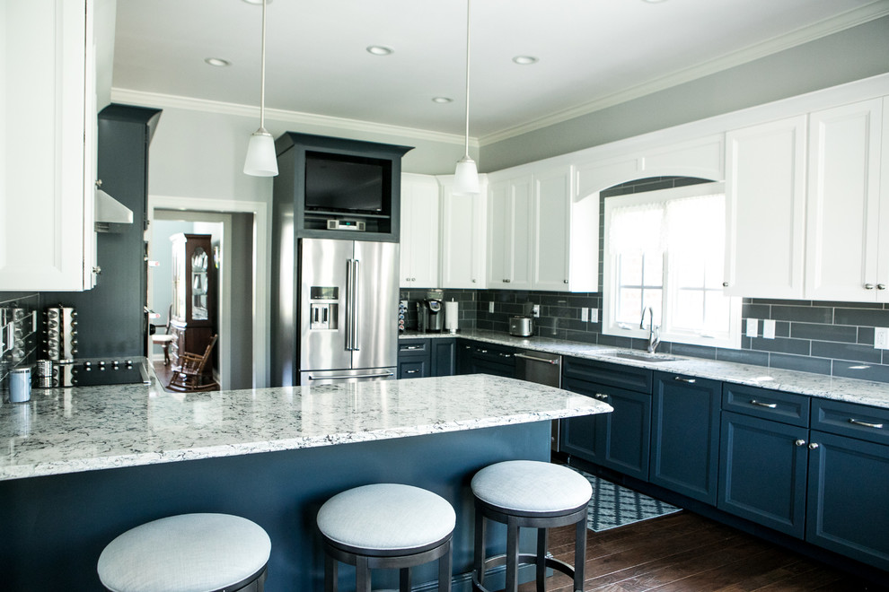 Inspiration for a large transitional kitchen in Indianapolis with an undermount sink, recessed-panel cabinets, blue cabinets, quartzite benchtops, blue splashback, porcelain splashback, stainless steel appliances, dark hardwood floors, a peninsula and brown floor.