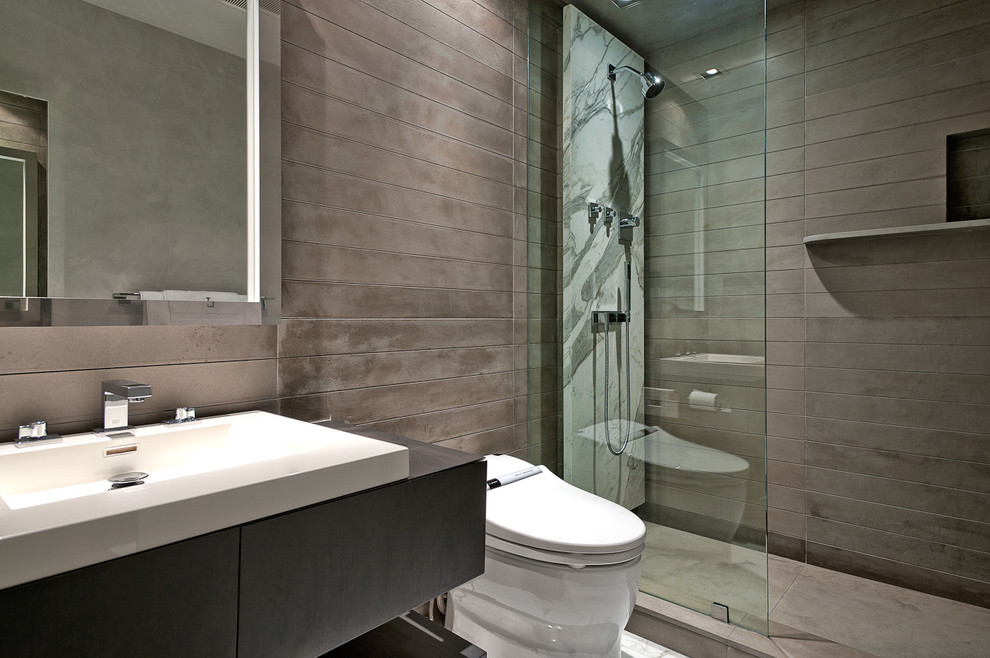This is an example of a mid-sized contemporary 3/4 bathroom in Miami with wood benchtops, a one-piece toilet, gray tile, grey walls and marble floors.