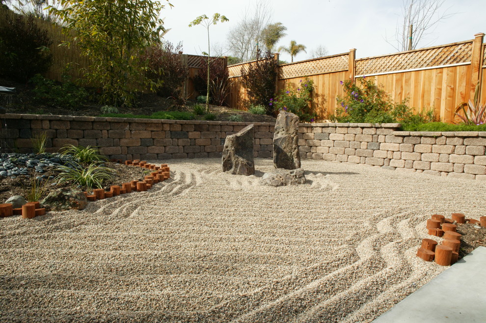 Photo of a mid-sized asian backyard partial sun xeriscape in San Diego with gravel.