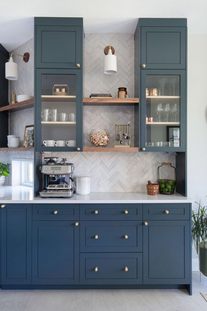 Inspiration for an expansive transitional l-shaped open plan kitchen in Austin with an undermount sink, shaker cabinets, blue cabinets, quartz benchtops, white splashback, ceramic splashback, stainless steel appliances, ceramic floors, with island, grey floor and white benchtop.
