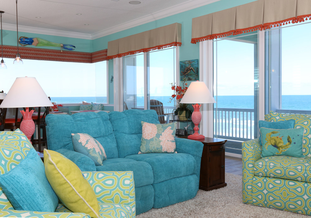 This is an example of a mid-sized beach style open concept living room in Orlando with blue walls, porcelain floors, a wall-mounted tv, beige floor and no fireplace.
