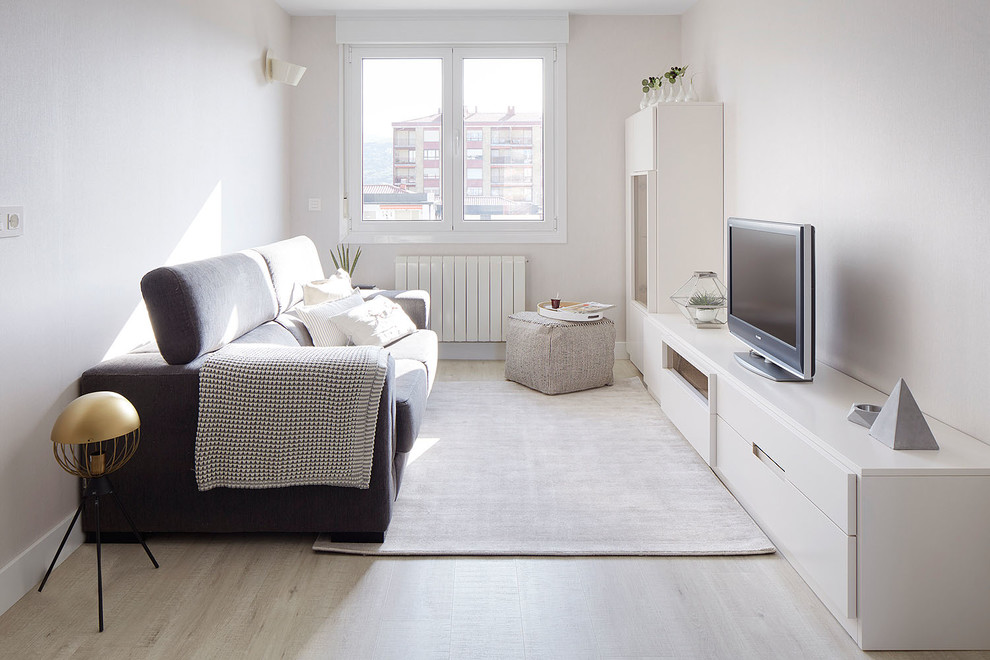 Photo of a small scandinavian open concept living room in Other with no fireplace, beige floor, white walls, laminate floors and a freestanding tv.