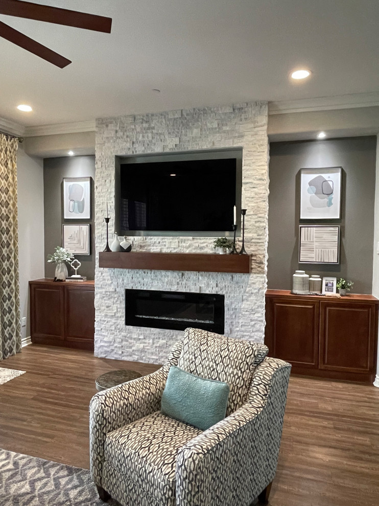 Inspiration for a small transitional enclosed laminate floor and brown floor home theater remodel in Other with gray walls and a wall-mounted tv