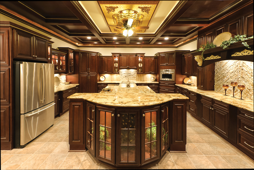 Small transitional l-shaped laminate floor and beige floor enclosed kitchen photo in Orange County with an undermount sink, beaded inset cabinets, dark wood cabinets, granite countertops, beige backsplash, stone slab backsplash, stainless steel appliances and an island