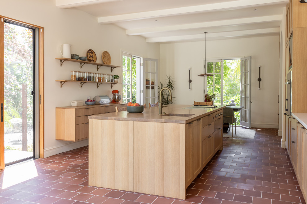 На фото: кухня среднего размера в стиле рустика с полом из керамической плитки, островом и красным полом