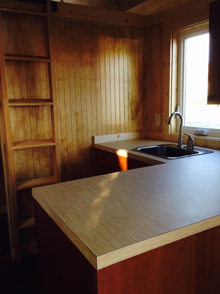 Small mountain style l-shaped eat-in kitchen photo in Seattle with laminate countertops, stainless steel appliances and no island