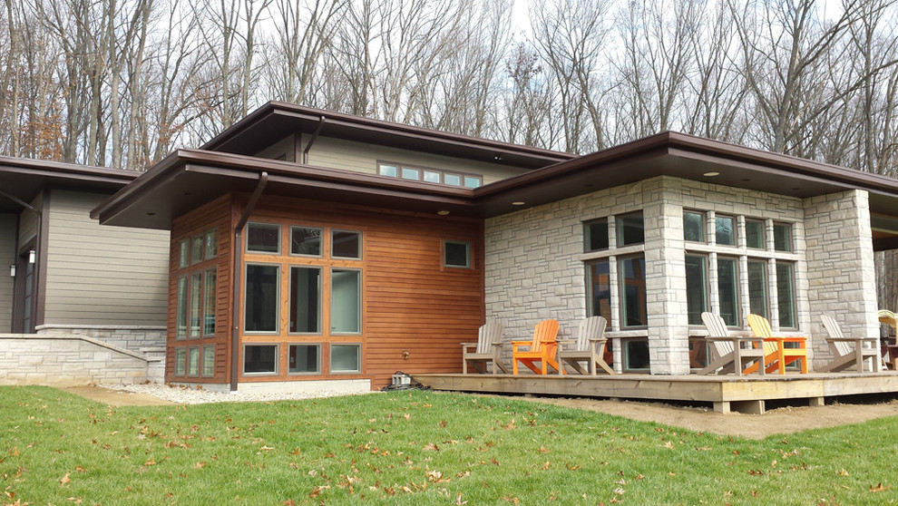 Inspiration for a mid-sized modern two-storey exterior in Indianapolis with mixed siding and a flat roof.